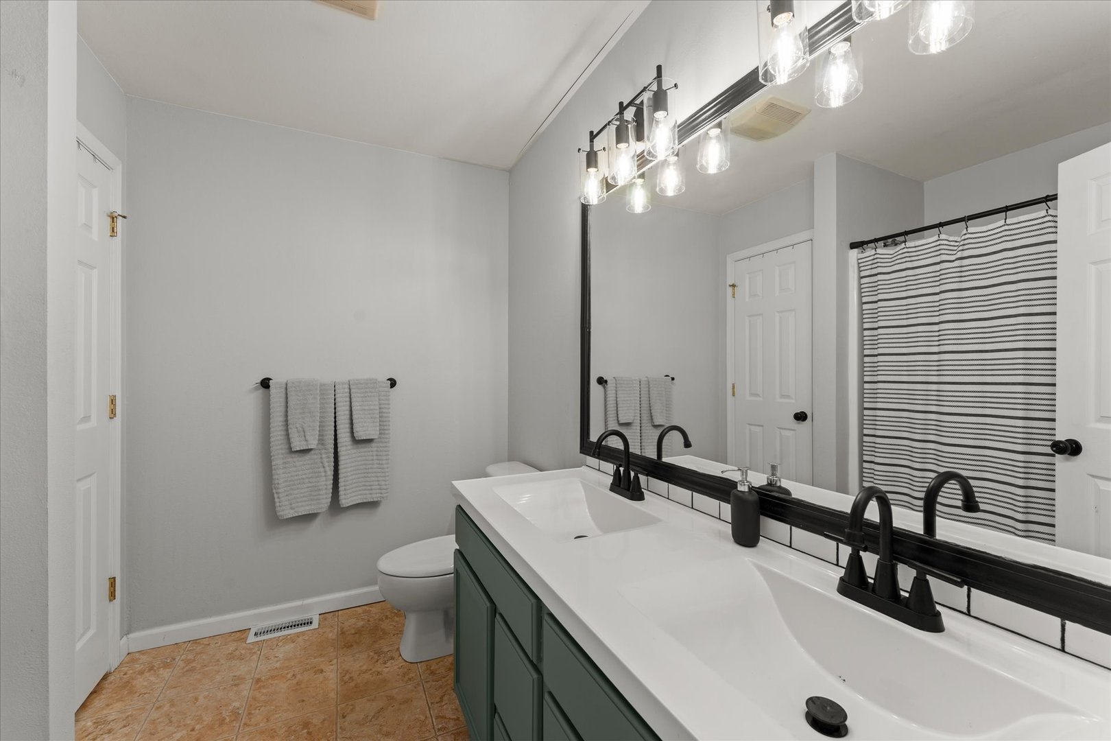 706 Northgate Drive St. Joseph, IL 61873 - Photo 18 of 33 a bathroom with a sink double vanity and a toilet