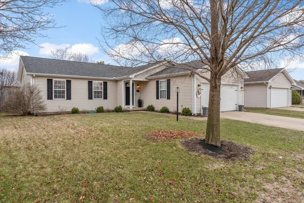 a front view of house with yard and trees