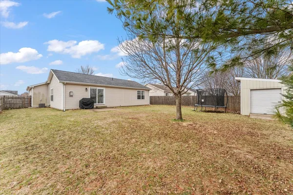 a front view of house with a garden