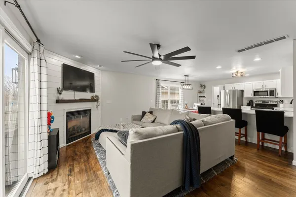 a living room with fireplace furniture and a flat screen tv