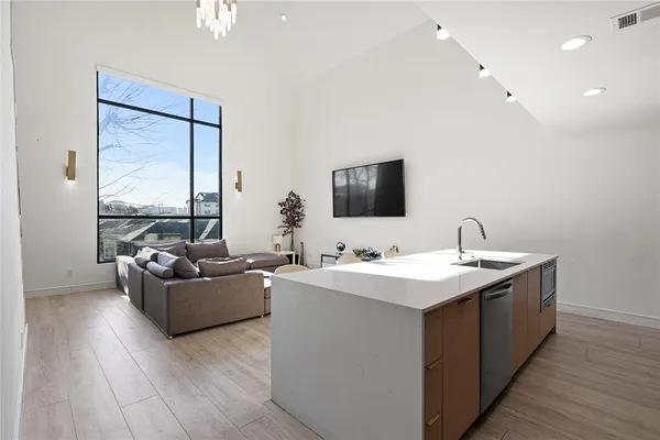 a living room with furniture wooden floor and a flat screen tv