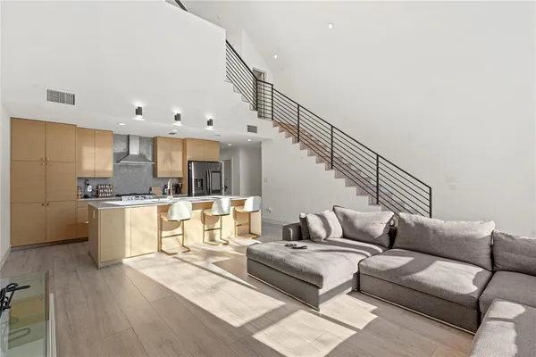a living room with furniture and kitchen view