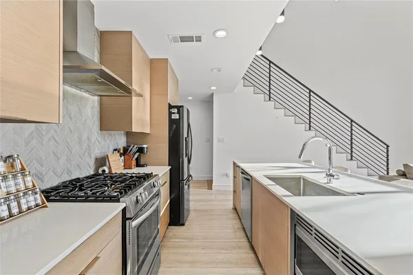 a kitchen with a sink stove and refrigerator