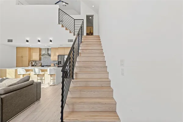 a view of entryway and hall with wooden floor