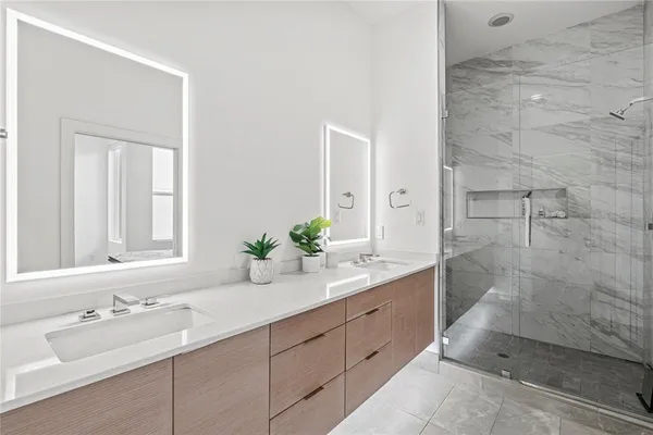 a bathroom with a double vanity sink and a mirror