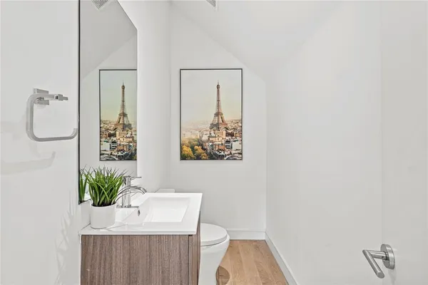 a bathroom with a sink a toilet and mirror