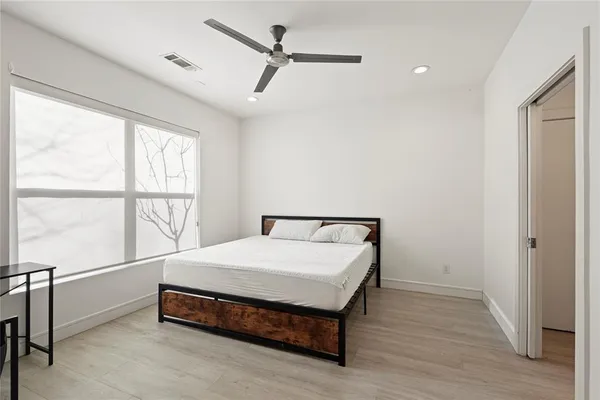 a bed sitting in a room next to a window