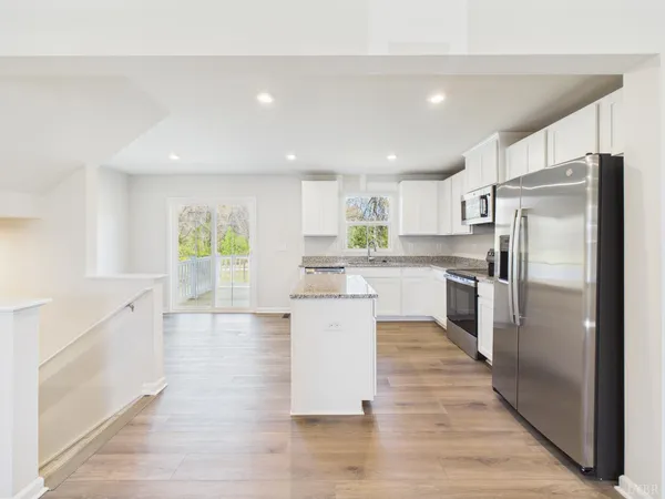 a kitchen with a refrigerator and a sink