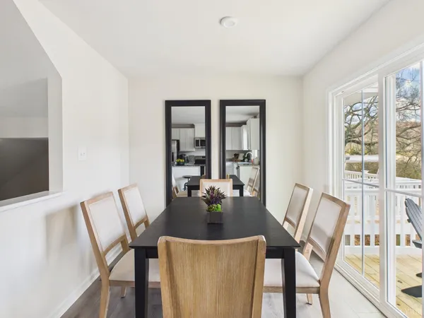 a view of a dining room with furniture large windows and wooden floor