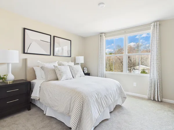 a bedroom with a large bed and a window