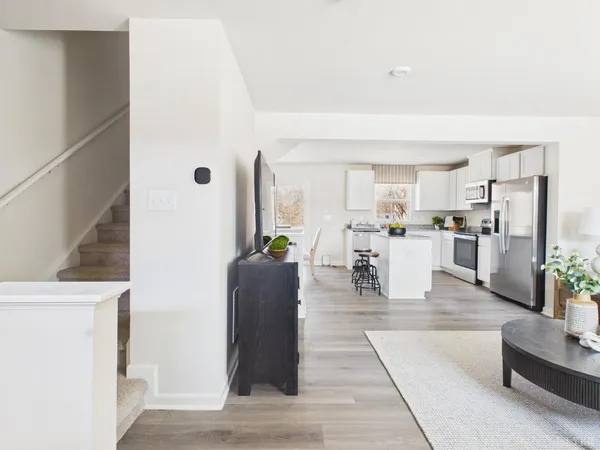a living room with furniture and a kitchen view