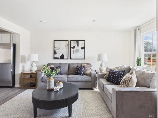 a living room with furniture and a large window