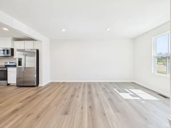 a view of kitchen with wooden floor electronic appliances and window