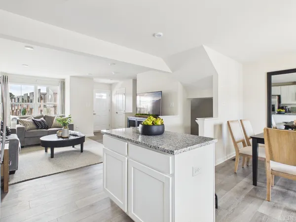 a living room with granite countertop furniture and a dining table