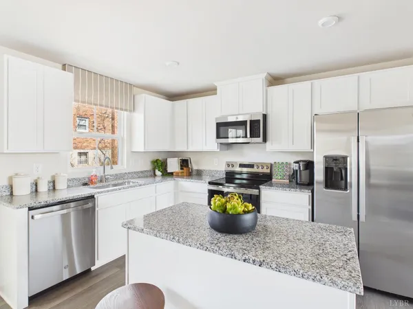 a kitchen with a sink a stove and cabinets
