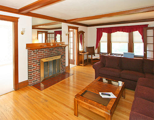 12 Lovell Road Watertown, MA 02472 - Photo 3 of 20 a living room with furniture a fireplace and a floor to ceiling window