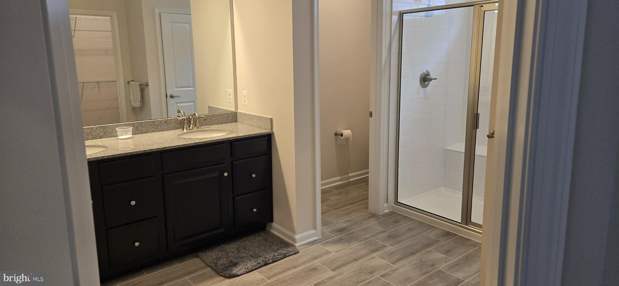 14164 Jaeger Road Clarksburg, MD 20871 - Photo 14 of 27 a bathroom with a double vanity sink and a mirror