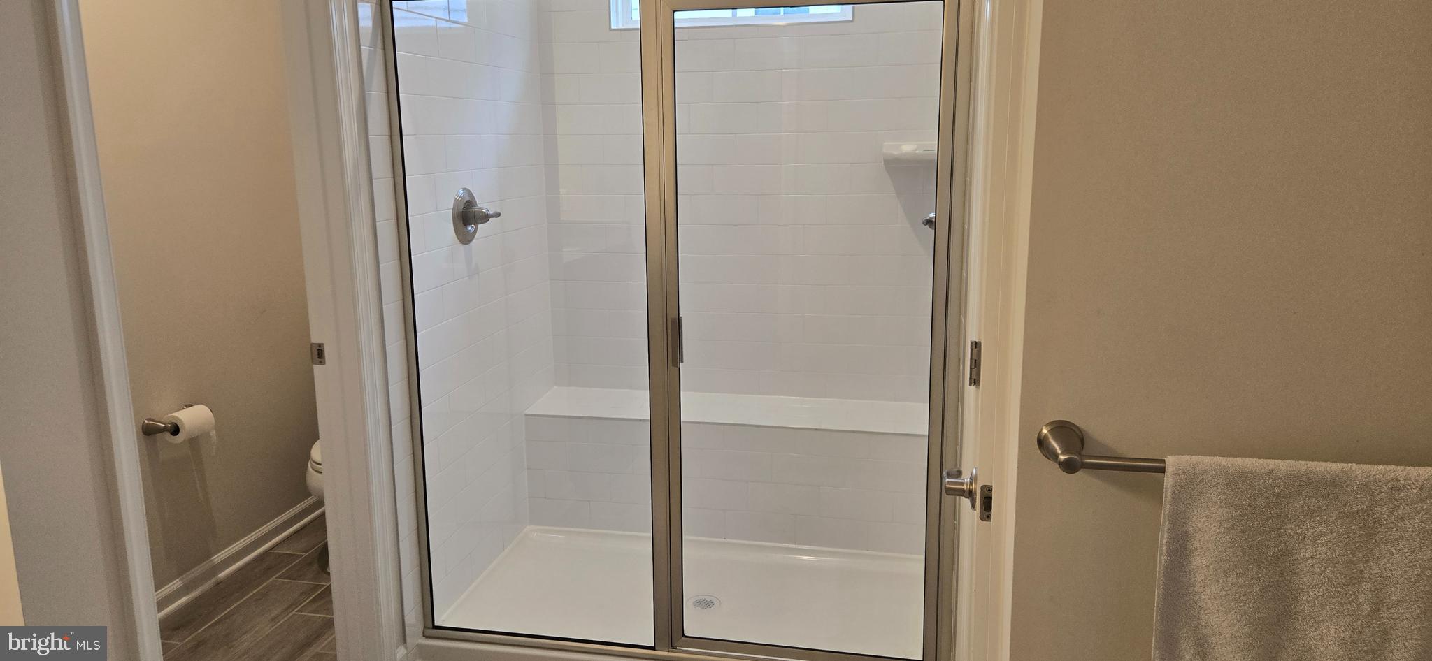 14164 Jaeger Road Clarksburg, MD 20871 - Photo 15 of 27 a bathroom with a glass shower door