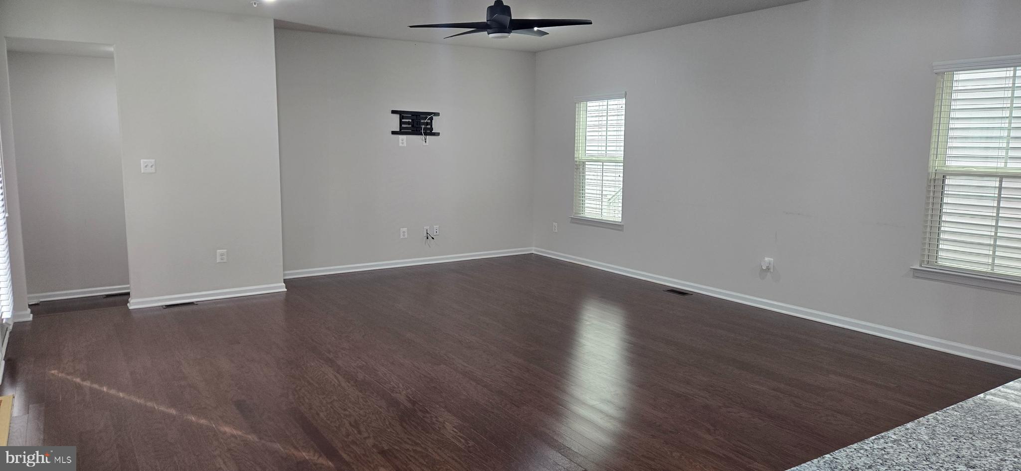 14164 Jaeger Road Clarksburg, MD 20871 - Photo 4 of 27 an empty room with wooden floor and windows