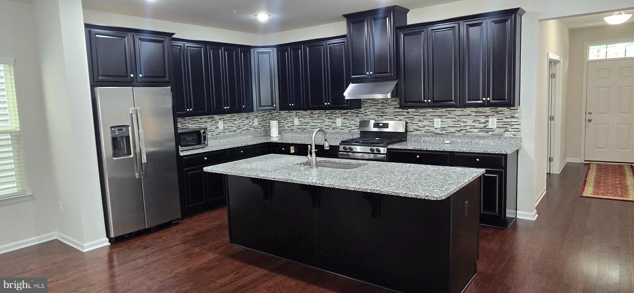 14164 Jaeger Road Clarksburg, MD 20871 - Photo 5 of 27 a kitchen with stainless steel appliances granite countertop wooden cabinets a refrigerator and a sink