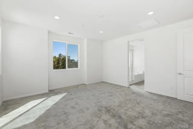 an empty room with a empty space and windows