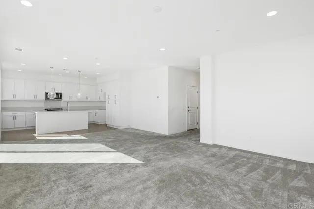 a view of kitchen with refrigerator sink and cabinets