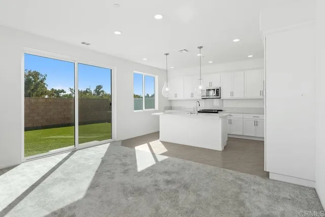 a kitchen with stainless steel appliances kitchen island granite countertop a sink and cabinets
