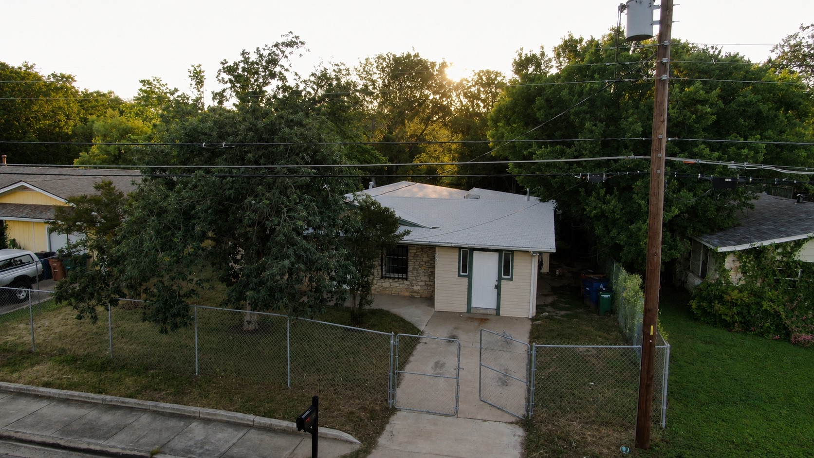 1060 Gardner Road Austin, TX 78721 - Photo 2 of 19 Securely fenced, this property offers a compact, single-story home with mature trees providing natural shading.