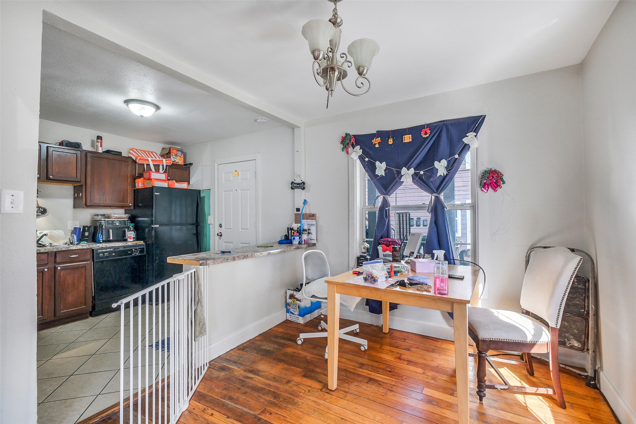 3435 Rosedale Street Houston, TX 77004 - Photo 16 of 34 a kitchen with stainless steel appliances granite countertop a dining table chairs and stove top oven