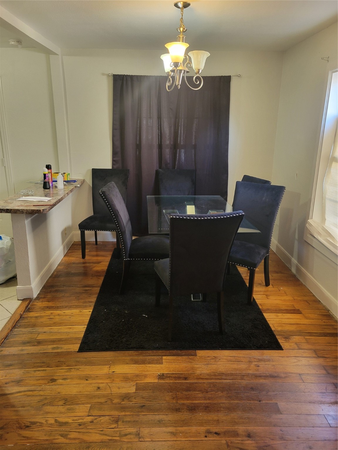 3435 Rosedale Street Houston, TX 77004 - Photo 23 of 34 a living room with dining table and wooden floor