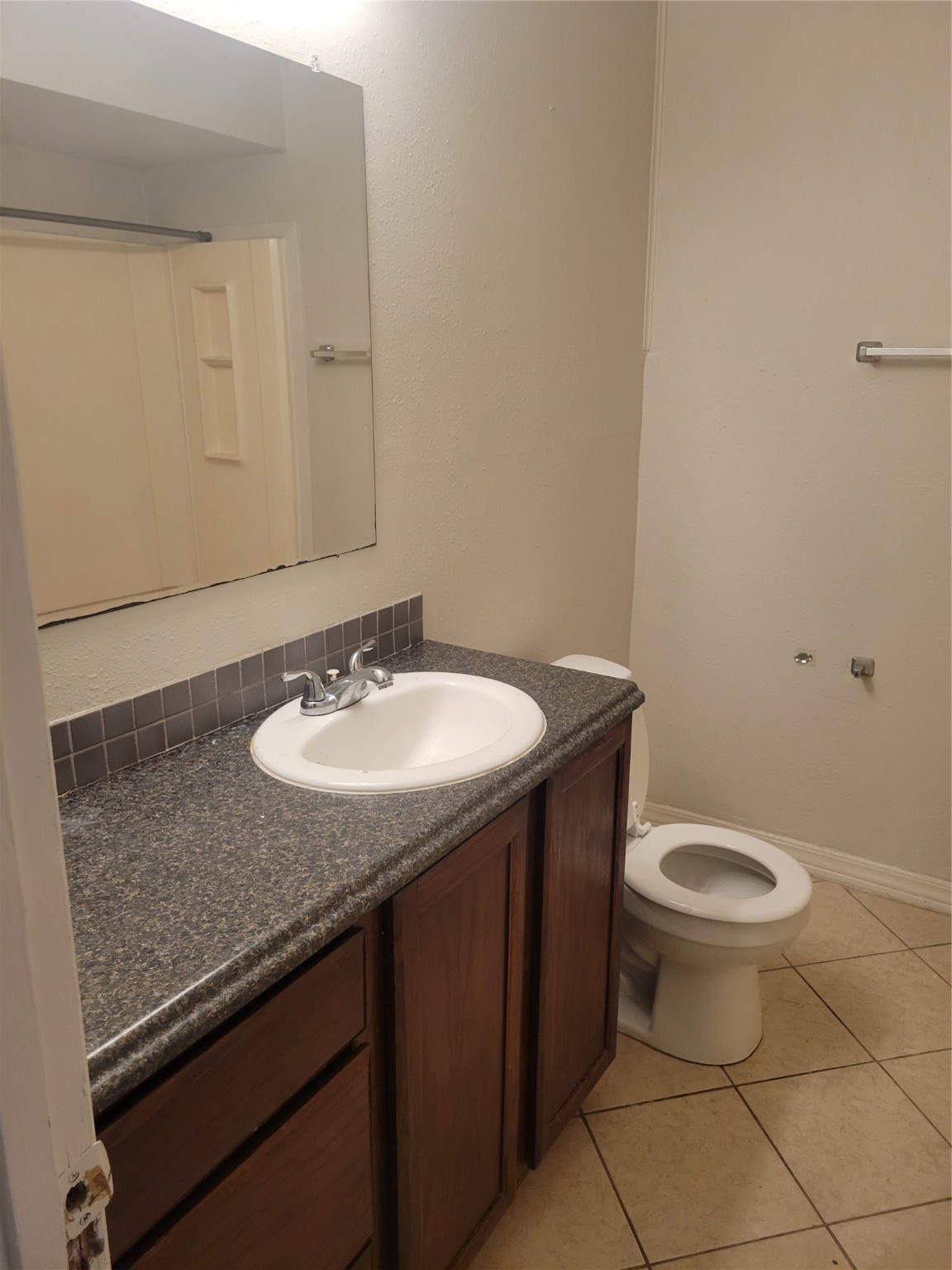 3435 Rosedale Street Houston, TX 77004 - Photo 26 of 34 a bathroom with a granite countertop sink and a toilet