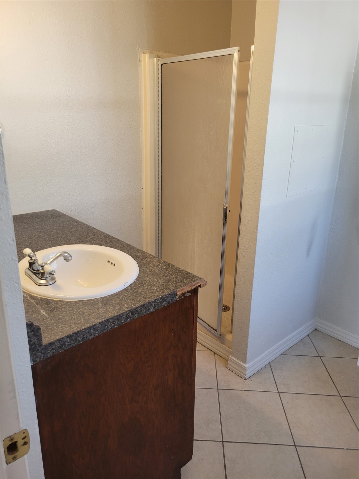 3435 Rosedale Street Houston, TX 77004 - Photo 30 of 34 a bathroom with a granite countertop sink and a mirror