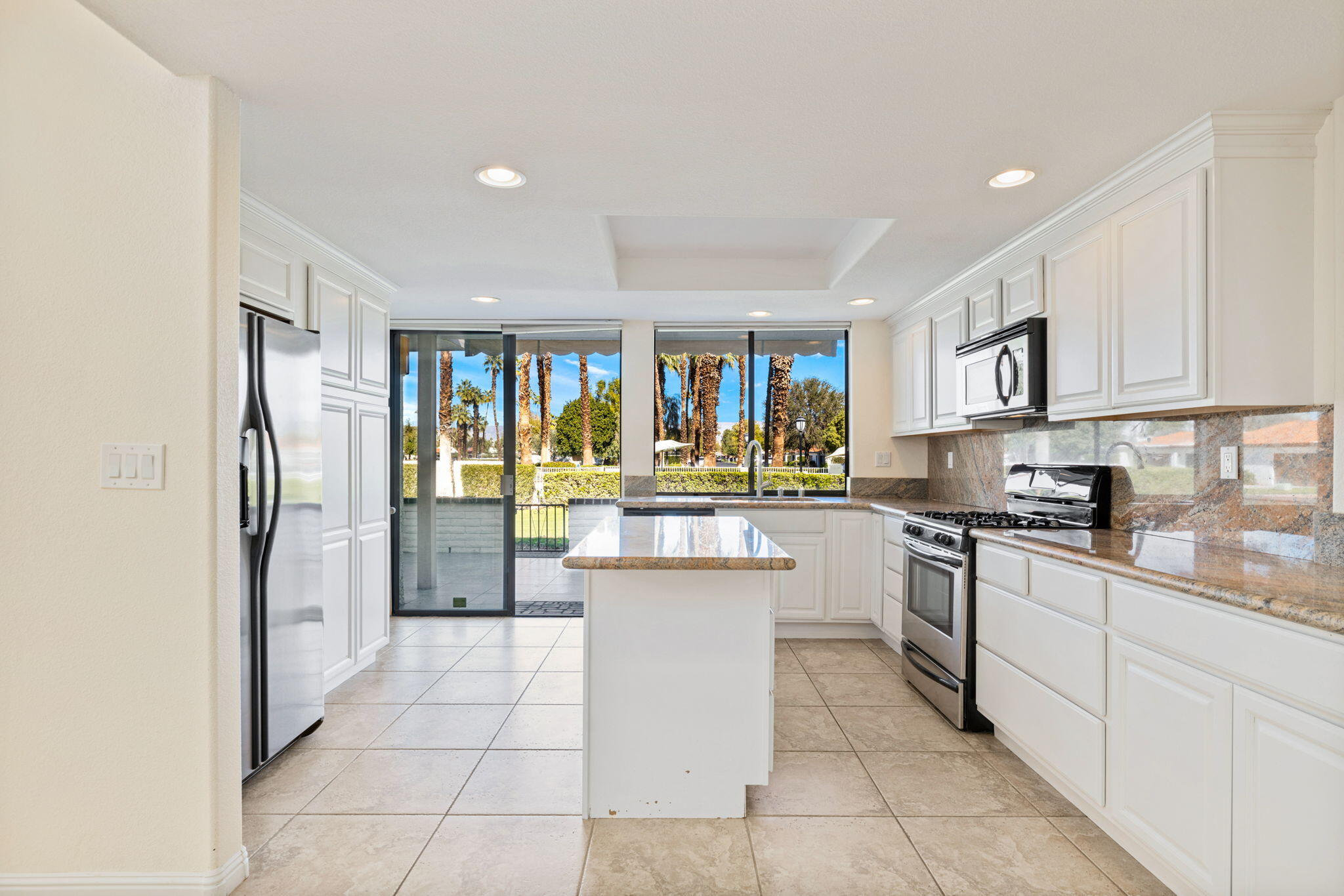 70 Durango Circle Rancho Mirage, CA 92270 - Photo 11 of 39 a kitchen with stainless steel appliances granite countertop a refrigerator and a stove top oven