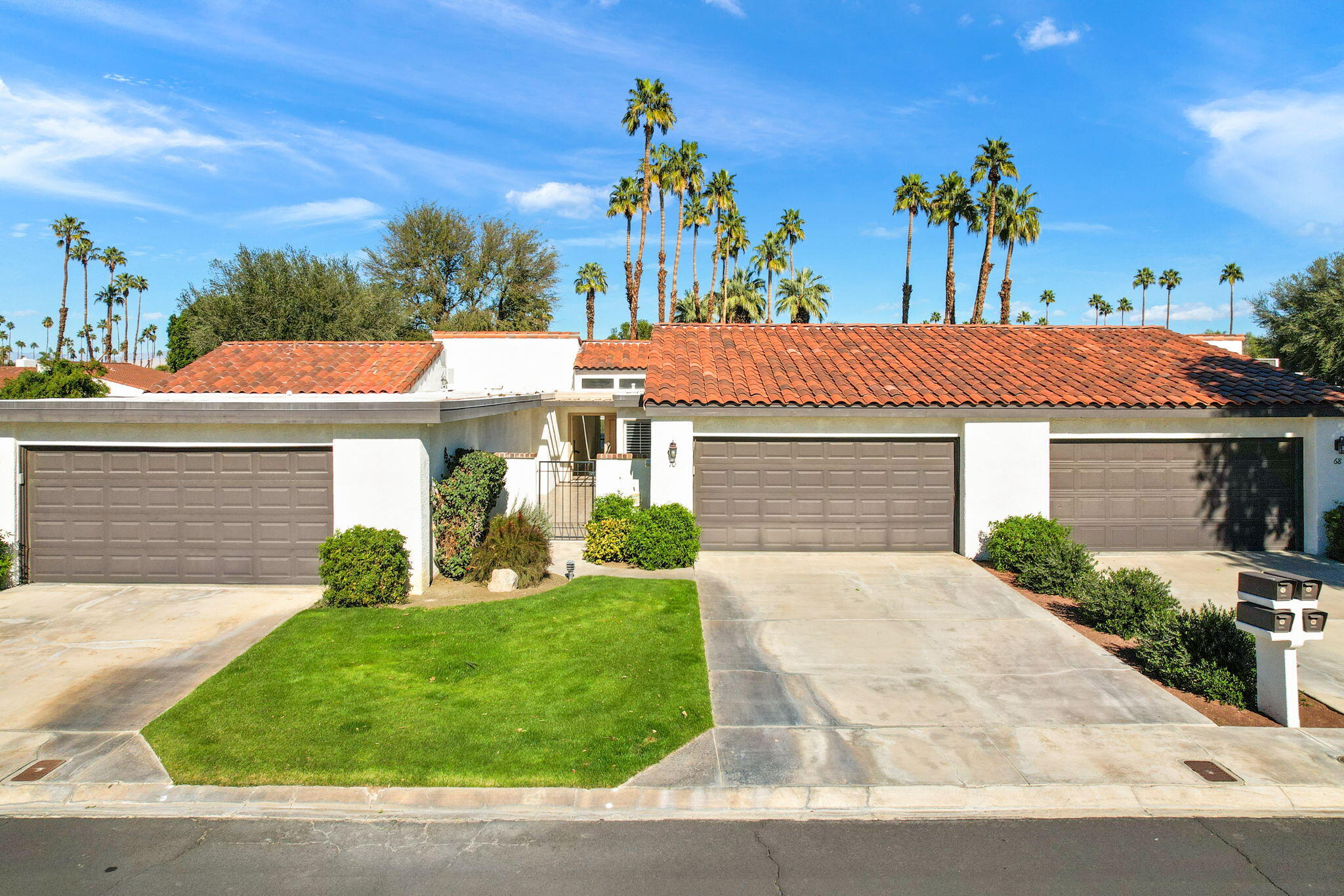 70 Durango Circle Rancho Mirage, CA 92270 - Photo 27 of 39 a front view of a house with a yard and potted plants