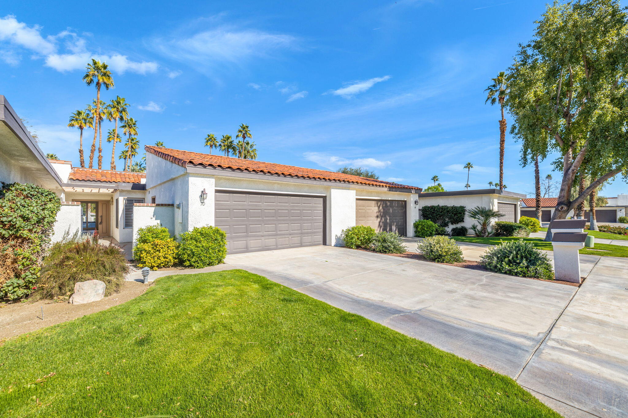 70 Durango Circle Rancho Mirage, CA 92270 - Photo 30 of 39 a front view of a house with a yard and potted plants