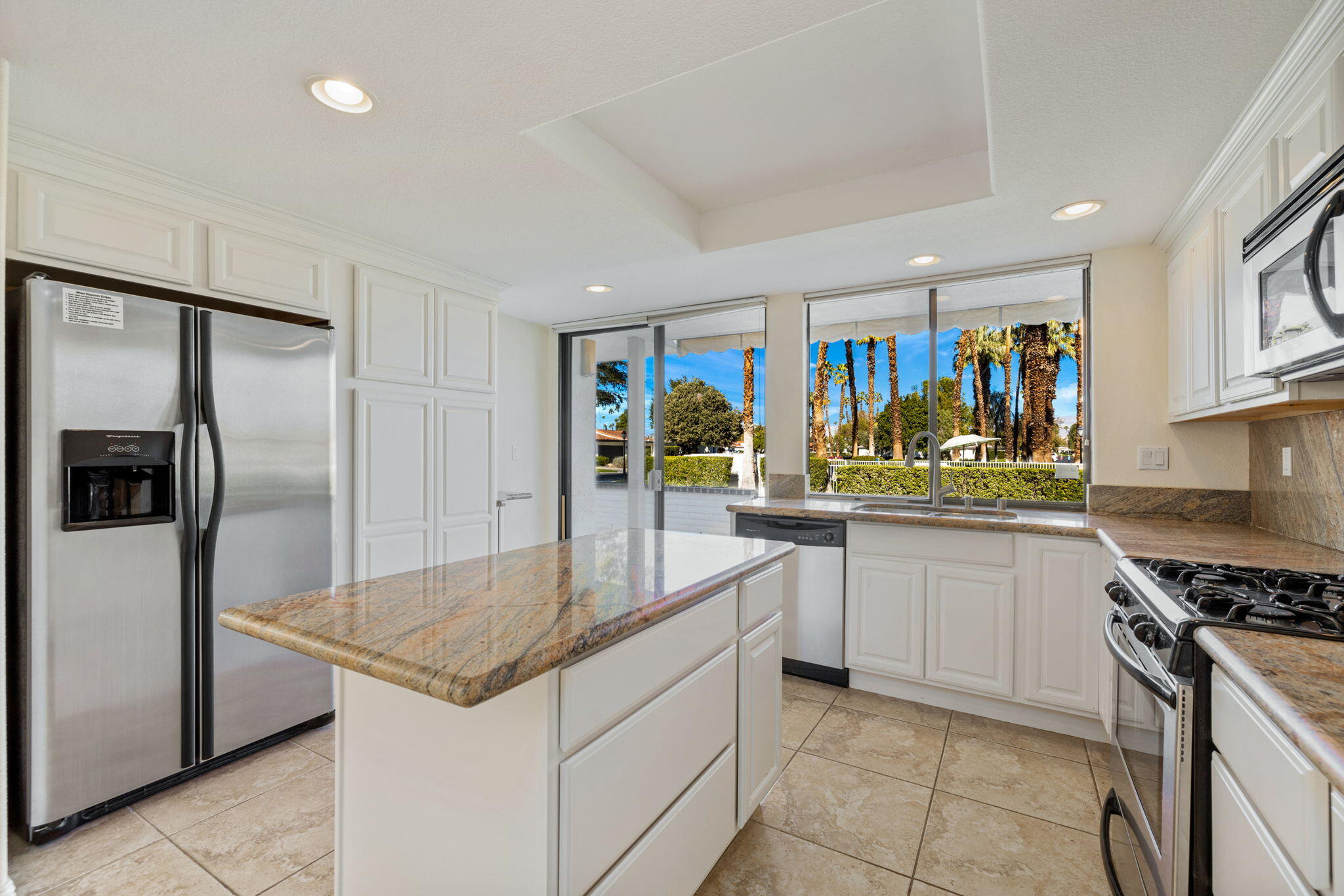 70 Durango Circle Rancho Mirage, CA 92270 - Photo 3 of 39 a kitchen with stainless steel appliances granite countertop a sink and a refrigerator
