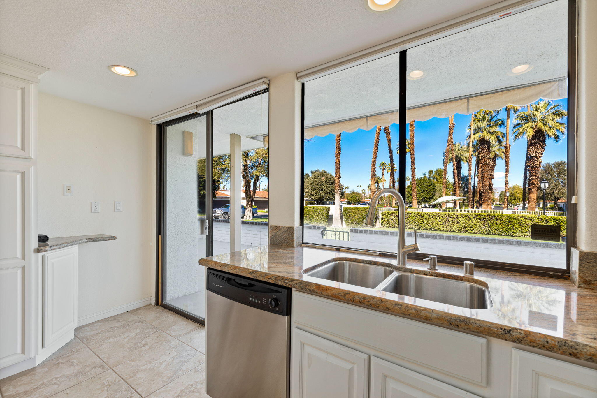 70 Durango Circle Rancho Mirage, CA 92270 - Photo 5 of 39 a kitchen with stainless steel appliances granite countertop a sink and a large window