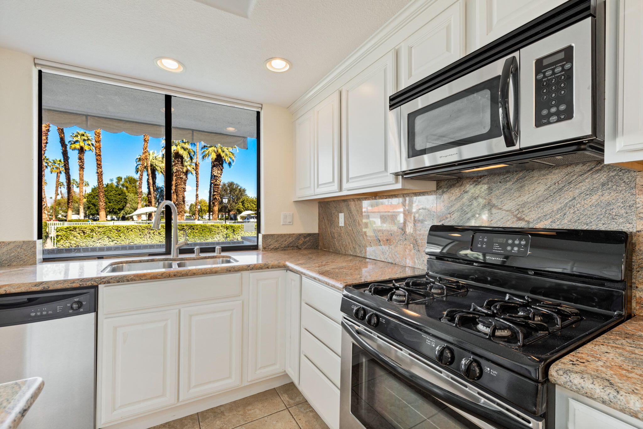 70 Durango Circle Rancho Mirage, CA 92270 - Photo 6 of 39 a kitchen with stainless steel appliances granite countertop a stove and a microwave