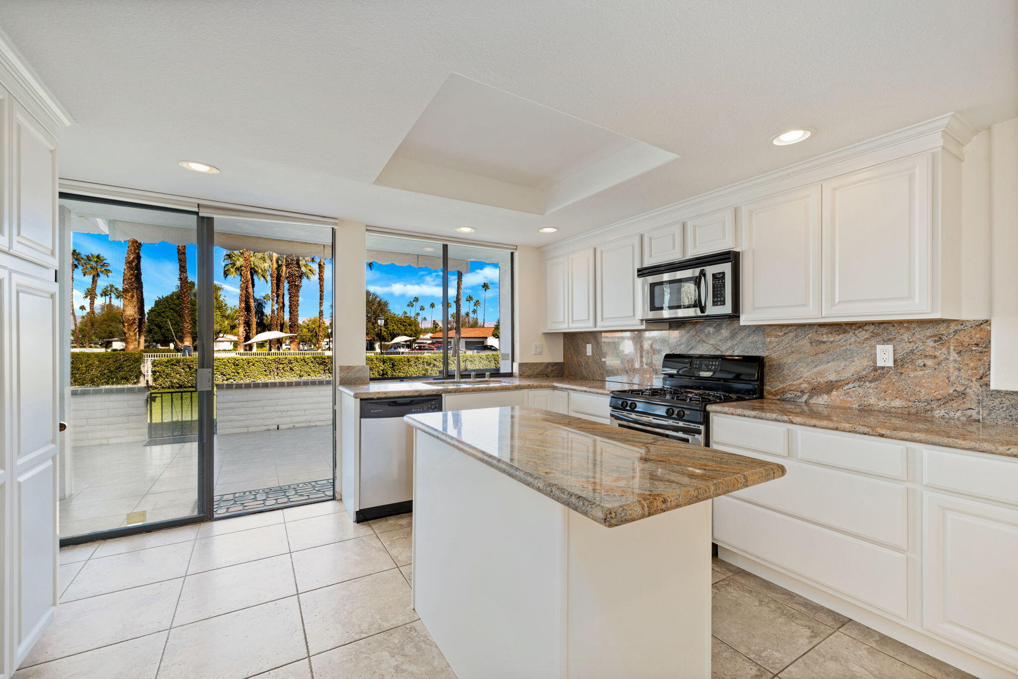 70 Durango Circle Rancho Mirage, CA 92270 - Photo 7 of 39 a kitchen with stainless steel appliances granite countertop a refrigerator a stove top oven a sink a dining table and chairs
