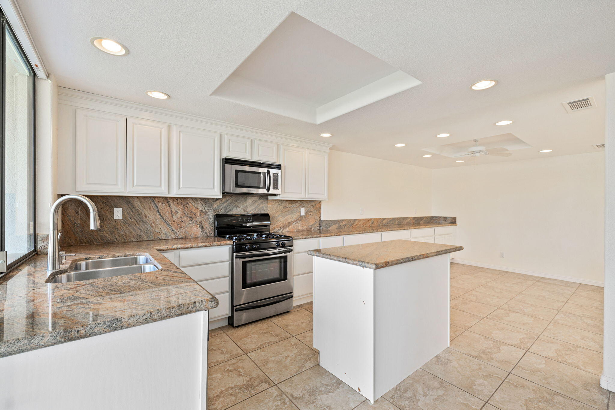 70 Durango Circle Rancho Mirage, CA 92270 - Photo 8 of 39 a kitchen with stainless steel appliances granite countertop a stove a sink and a microwave