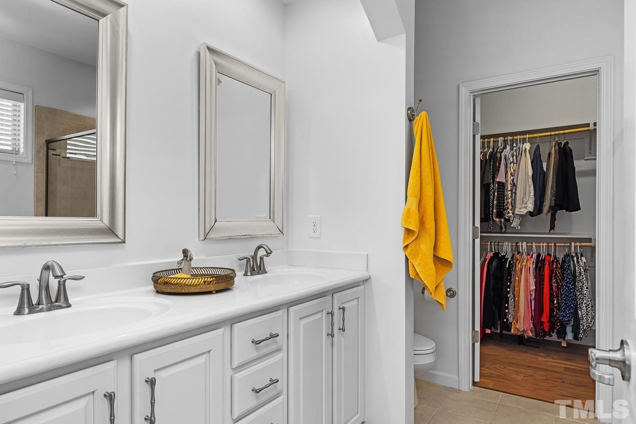 5528 Wade Park Boulevard Raleigh, NC 27607 - Photo 18 of 30 a bathroom with a sink and a mirror
