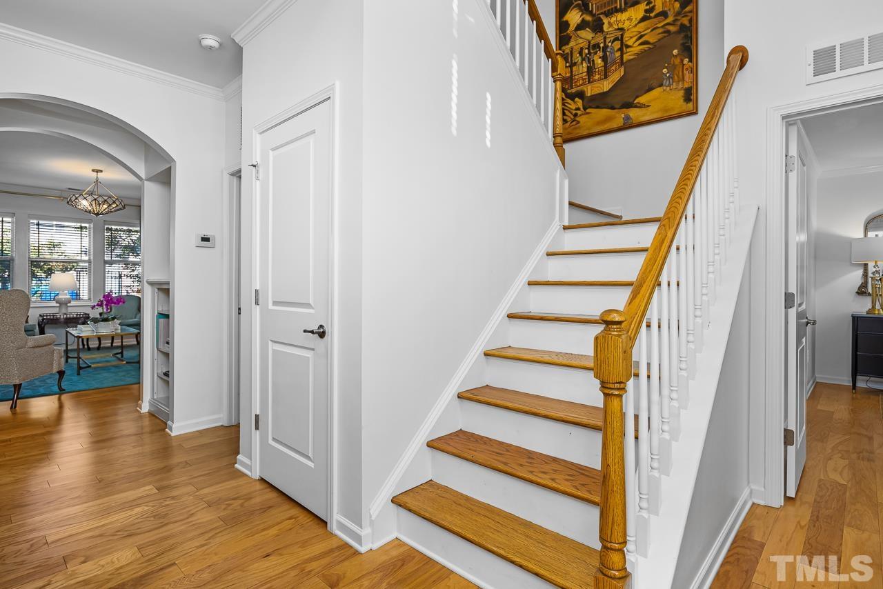 5528 Wade Park Boulevard Raleigh, NC 27607 - Photo 22 of 30 a view of a hallway with wooden floor and staircase