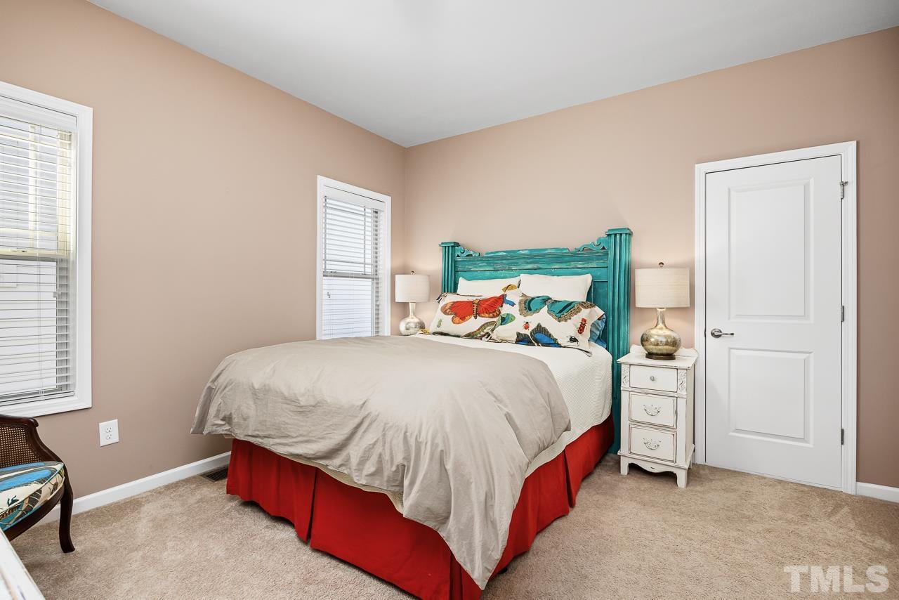 5528 Wade Park Boulevard Raleigh, NC 27607 - Photo 24 of 30 a bedroom with a bed and window
