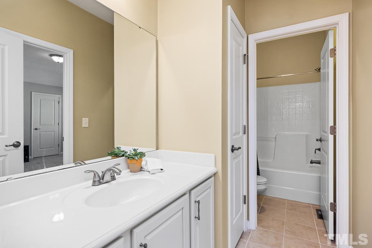 5528 Wade Park Boulevard Raleigh, NC 27607 - Photo 26 of 30 a bathroom with a sink and a mirror