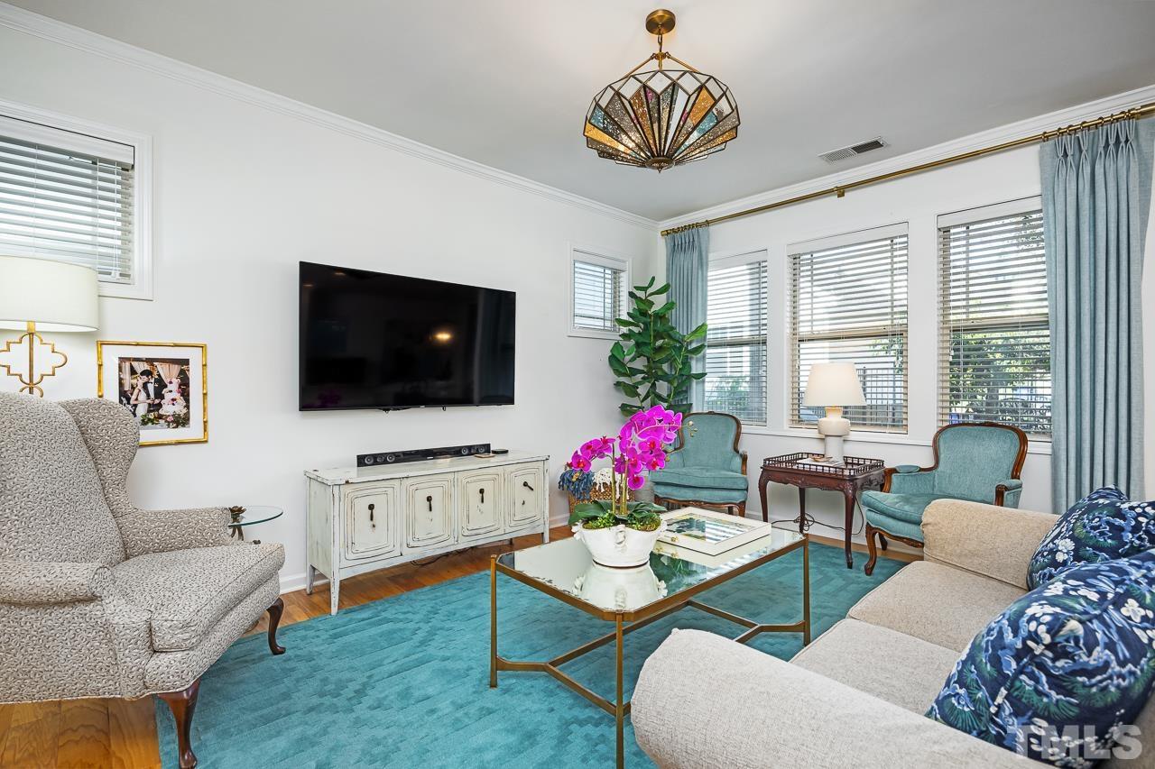 5528 Wade Park Boulevard Raleigh, NC 27607 - Photo 7 of 30 a living room with furniture chandelier and a flat screen tv