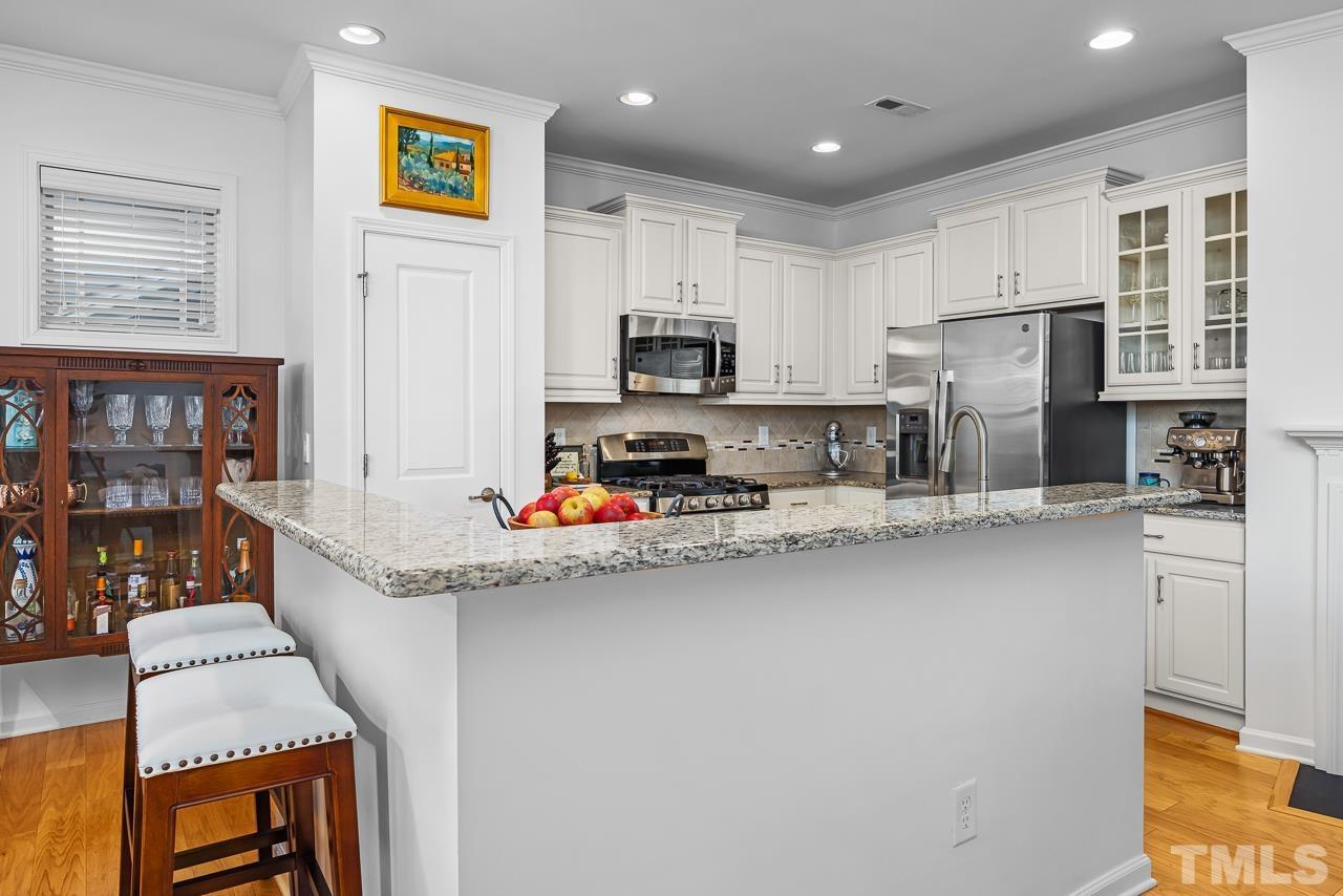 5528 Wade Park Boulevard Raleigh, NC 27607 - Photo 10 of 30 a kitchen that has a lot of cabinets and wooden floor