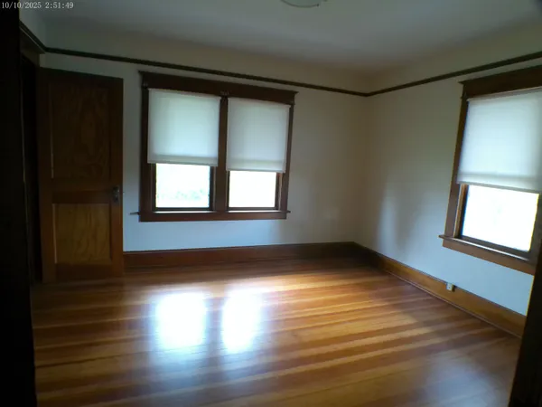 a view of a big room with a big yard and large trees
