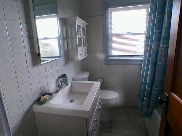 a front view of a house with a yard covered with snow in front of house