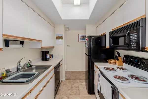 a kitchen that has a sink and a stove top oven