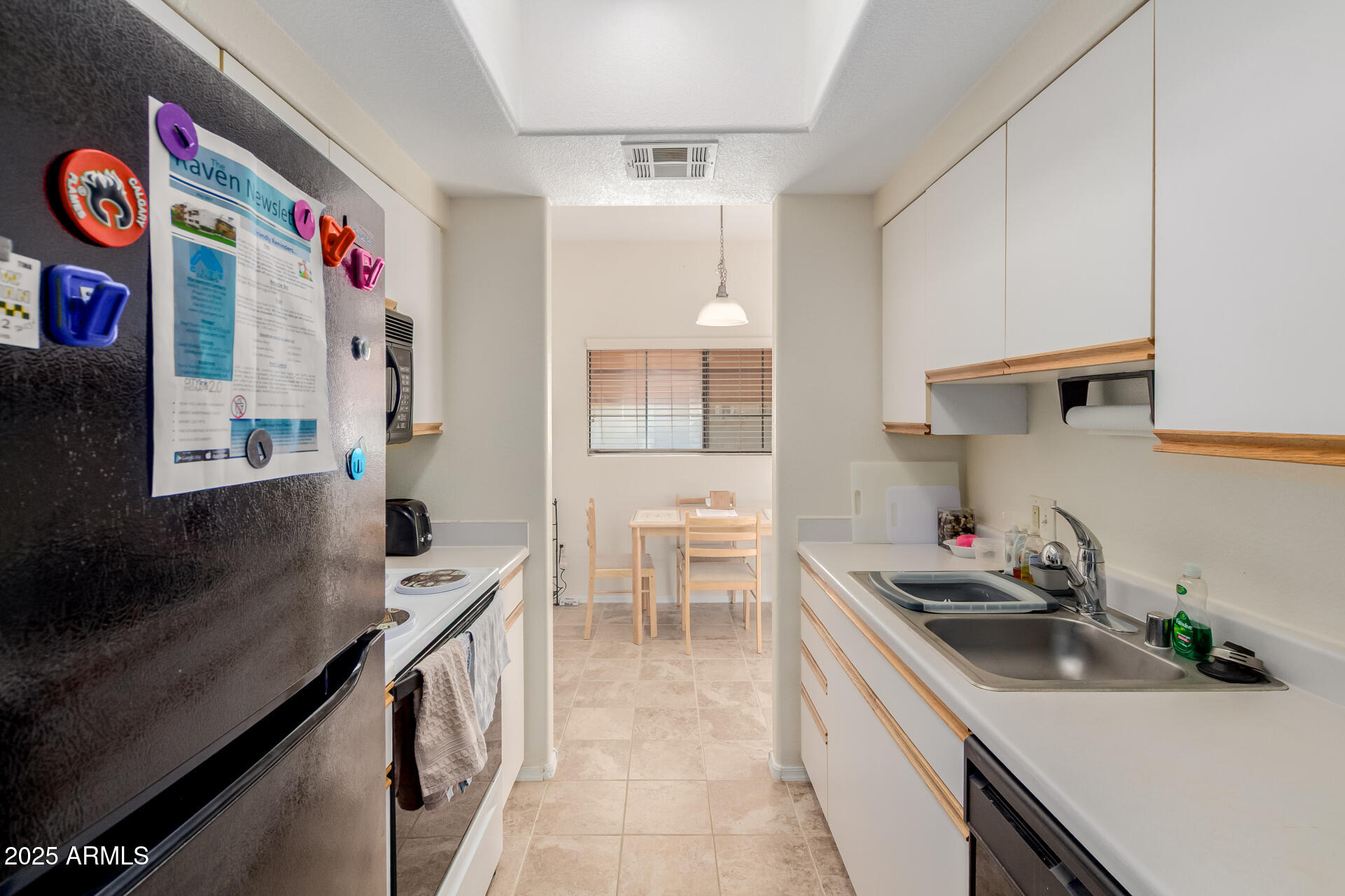 3434 East Baseline Road, Unit 246 Phoenix, AZ 85042 - Photo 13 of 43 a kitchen with stainless steel appliances a sink dishwasher and a stove with wooden floor